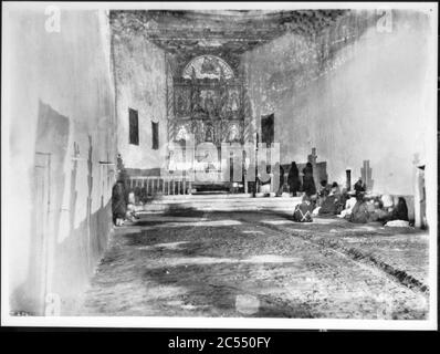 Interior of the old church during early morning mass at the Acoma Pueblo, New Mexico, 1886 Stock Photo