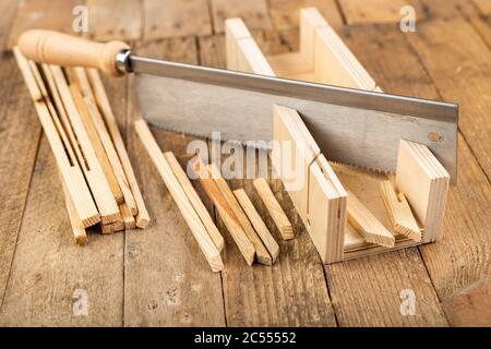 Cutting wooden slats at an angle. Small works in the carpentry shop. Workplace home workshop. Stock Photo