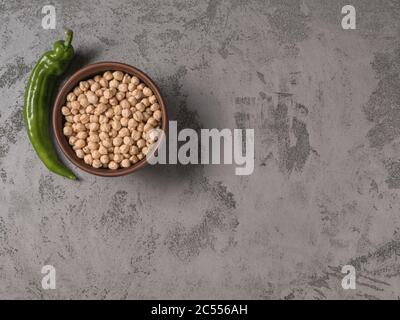 Chickpeas in a bowl and selenay chilli. The gray background. Stock Photo