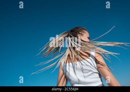 Beautiful woman waving hair with stylish afro braids Stock Photo