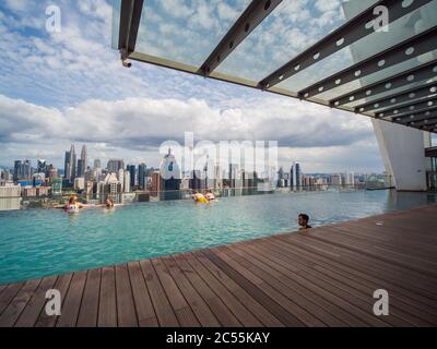 Kuala Lumpur, Malaysia - January 21, 2019: Swimming pool on roof top with beautiful city view. Stock Photo