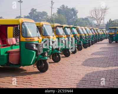 Yellow and green auto rickshaws in Indiya. Stock Photo