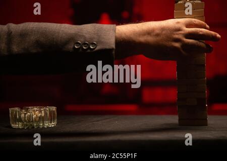 Closeup shot of a person picking on the piled wooden brick Stock Photo