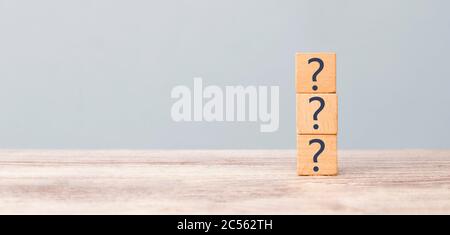 Question marks on the table written in a row on cubes. Frequently asked questions concept Stock Photo