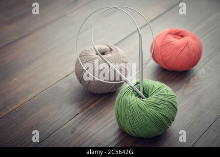 Colored yarn balls on wooden background closeup Stock Photo
