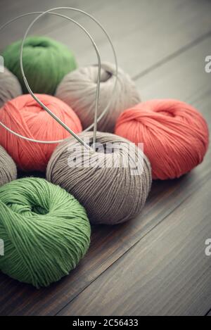 Colored yarn balls on wooden background closeup Stock Photo
