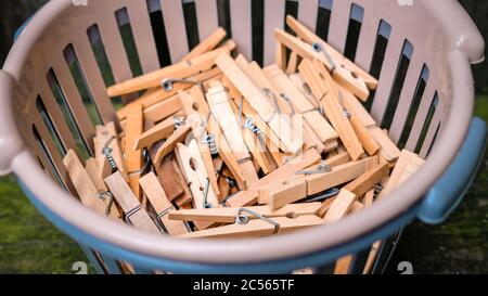 A basket of clothespins outside in the garden on laundry day Stock Photo