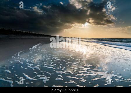 Evening mood on the beach of the Baltic Sea, calm water, clouds, sunset, reflection Stock Photo