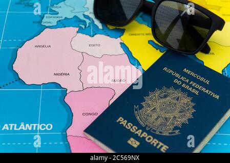 Top view of Brazilian passport over map. Focus on the North American continent. Emigration, travel, destination concept. Stock Photo