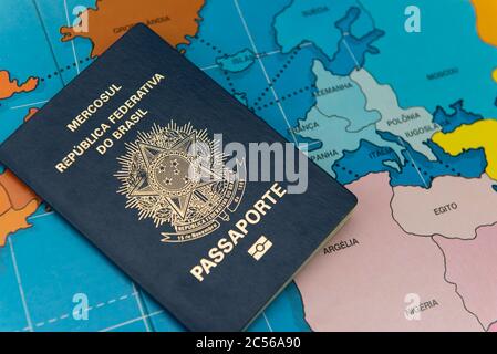 Top view of Brazilian passport over map. Focus on the European and African continent. Emigration, travel, destination concept. Translate: Mercosur, Fe Stock Photo