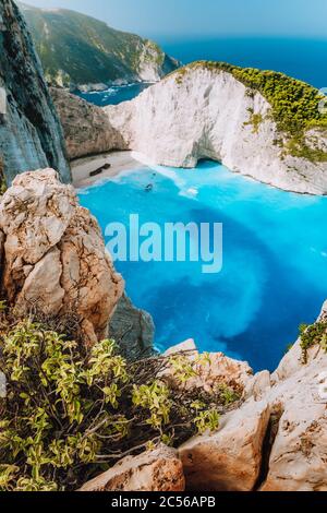 Navagio beach from top rocks at Zakynthos island, Greece. Stranded freightliner ship in unique beautiful blue lagoon and rocky mountains. Stock Photo