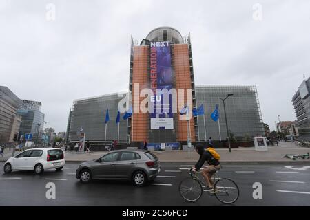 Brussels, Belgium. 30th June, 2020. A rider and vehicles are seen near the headquarters of the European Commission in Brussels, Belgium, June 30, 2020. The Council of the European Union (EU) on Tuesday adopted a recommendation to lift entry restrictions for residents of some third countries starting Wednesday, and the United States is noticeably shut out. Credit: Zheng Huansong/Xinhua/Alamy Live News Stock Photo