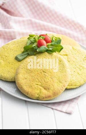 Indian pita bread with green salad and tomato on plate. Stock Photo