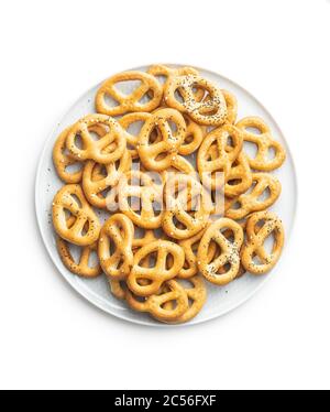 Crispy salted pretzels on plate isolated on white background Stock Photo