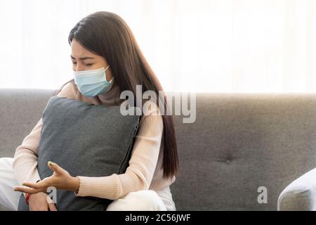 Portait of asian female patient with face mask talking to Psychotherapist doctor for consult about her mental health. Stock Photo