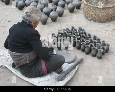 High angle shot of an aged female working in a pottery workshop in Nepal Stock Photo