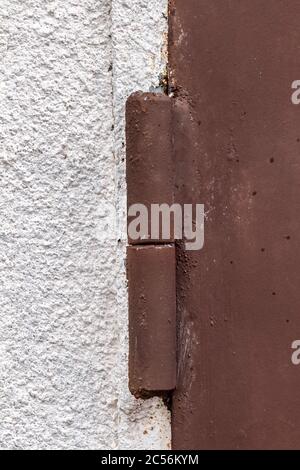 Hinge of an iron garage door close-up. Stock Photo