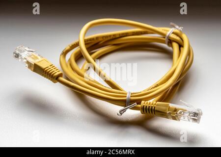 Yellow network cable rolled up in a skein close-up. Stock Photo