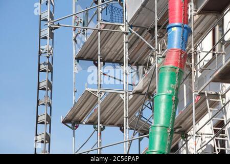 Construction site, downpipe for building rubble on the facade of a scaffolded house, Bremen, Germany, Europe Stock Photo
