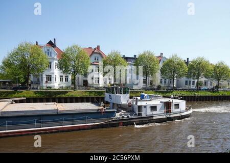 Barge and neoclassical apartment buildings on the coastal canal, Oldenburg in Oldenburg, Lower Saxony, Germany, Europe Stock Photo