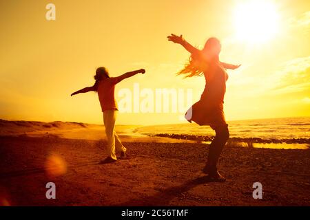 Young couple dancing on the beach Stock Photo