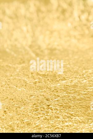 Crumpled golden aluminum foil background, abstract texture Stock Photo