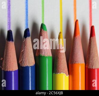 Colored pencils in rainbow spectral order against corresponding drawn lines Stock Photo