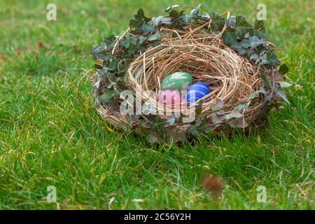 Nest of natural-colored Easter eggs in the garden Stock Photo