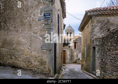 Village street in La Livinière with a view of the dome of the Saint Étienne church. Built in the XIV century. Monument historique Stock Photo