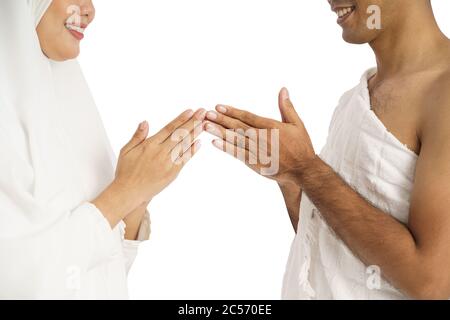 muslim asian couple shake hands. umrah and hajj celebration Stock Photo