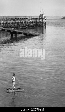 Boy on raft, Mouth of the River Tyne, North Shields, circa 1975 Stock Photo