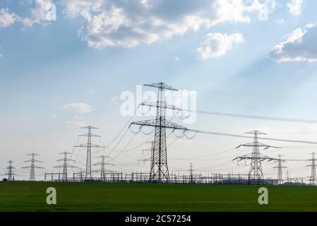 Germany, Saxony-Anhalt, Wolmirstedt: Electricity pylons are close together at the substation. From here, a 580 km long power line from Saxony-Anhalt t Stock Photo