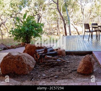 A fireplace near dining tables and chairs in an Australian outback restaurant in the bush Stock Photo