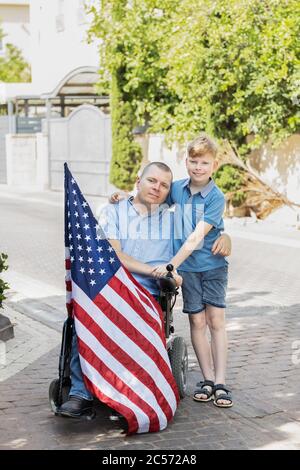 Young Boy with Disabled Father, We love our Country Stock Photo