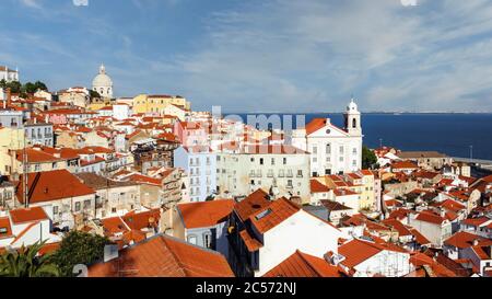 Lisbon, Portugal.  View over the old district of the Alfama with church of Santo Estevao to right and the Rio Tejo, or Tagus River, behind.