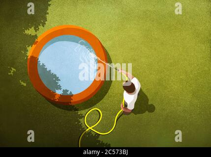 Man with hose filling wading pool in sunny backyard Stock Photo