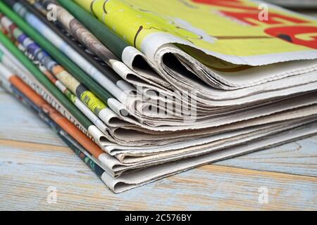 Selective focus shot of the stack of newspapers isolated on a wooden surface Stock Photo