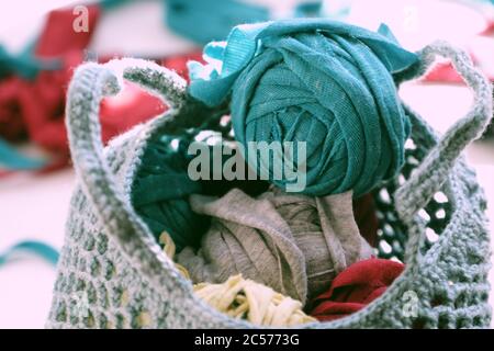 Close up ball of yarn in bag from recycle old t shirt, fun leisure with homemade reuse by cut clothes in yarns, colorful scene in sunlight morning Stock Photo