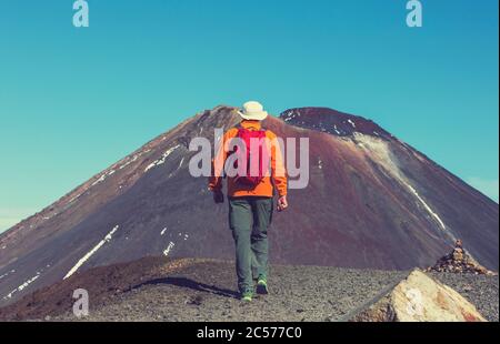 Man walking on hike trail route with Mount Cook National Park, beautiful mountains region. Tramping, hiking, travel in New Zealand. Stock Photo