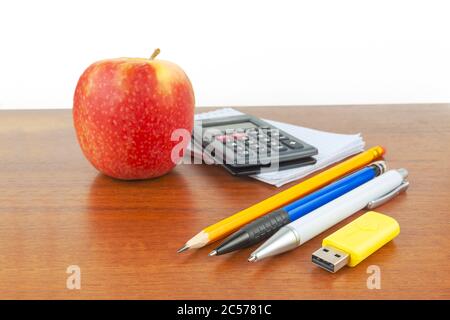 Apple pen notepad calculator lie on the table. Stock Photo