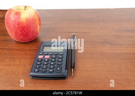 Apple calculator pen lie on the table. Stock Photo