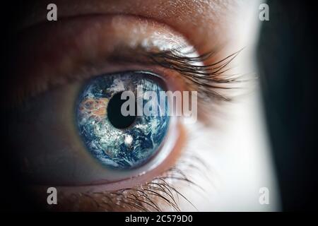 Macro photo of the woman's eye and Earth planet Stock Photo
