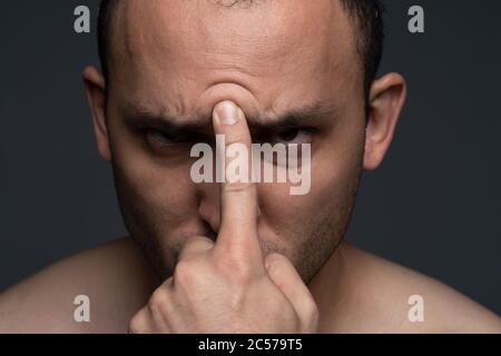 Photo of man with forefinger on forehead Stock Photo