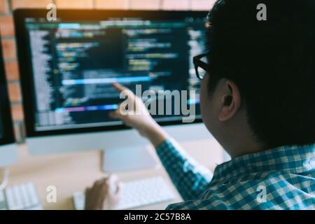 Hipster man hands pointing coding html and programming develop on screen computer. Stock Photo