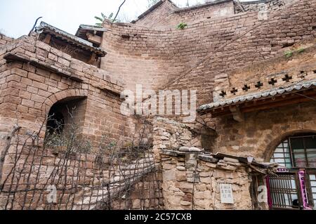 Layers of cave dwellings dug into the hillside in Lijiashan village, Shanxi Province, China. Stock Photo
