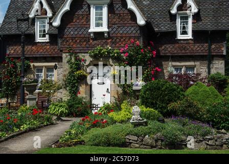 Pretty house and garden in the estate village of Ilam, Staffordshire, UK; many of the houses are built in the Swiss Chalet style. Stock Photo