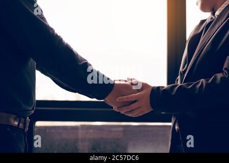 Business people compassionately holding hands at room office. Stock Photo