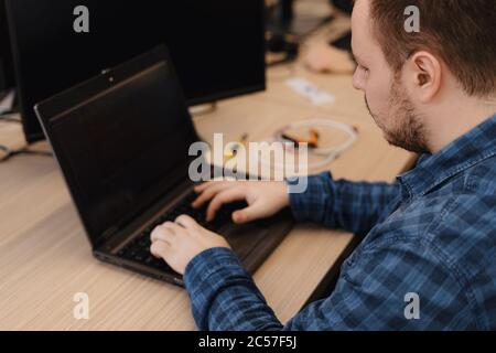 Authentic programmer working on desktop pc programming code technologies or website design at office Software Development Company Stock Photo