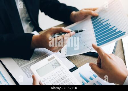 Businessman looking graph and summary report on document finance budget paper with analysis cost data result. Stock Photo
