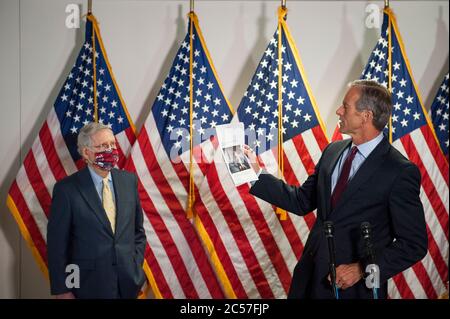 Washington, United States Of America. 30th June, 2020. United States Senator John Thune (Republican of South Dakota), holds up news articles relating to the Russia Taliban bounty story as he is joined by US Senate Majority Leader Mitch McConnell (Republican of Kentucky), left, and other Senate GOP leadership as he fields questions from reporters following the GOP luncheon in the Hart Senate Office Building on Capitol Hill in Washington, DC., Tuesday, June 30, 2020. Credit: Rod Lamkey/CNP | usage worldwide Credit: dpa/Alamy Live News Stock Photo